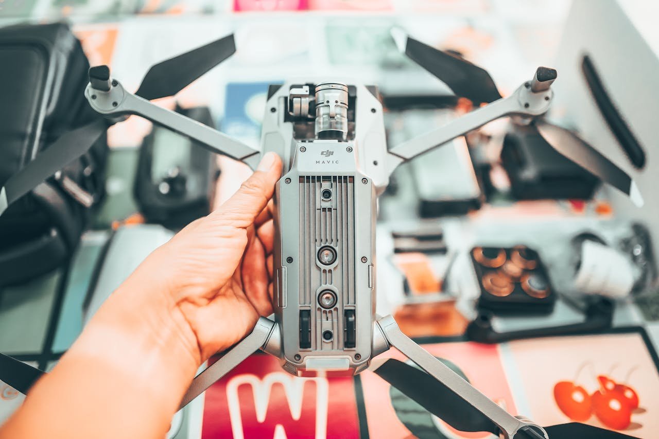 Unrecognizable photographer checking drone with camera